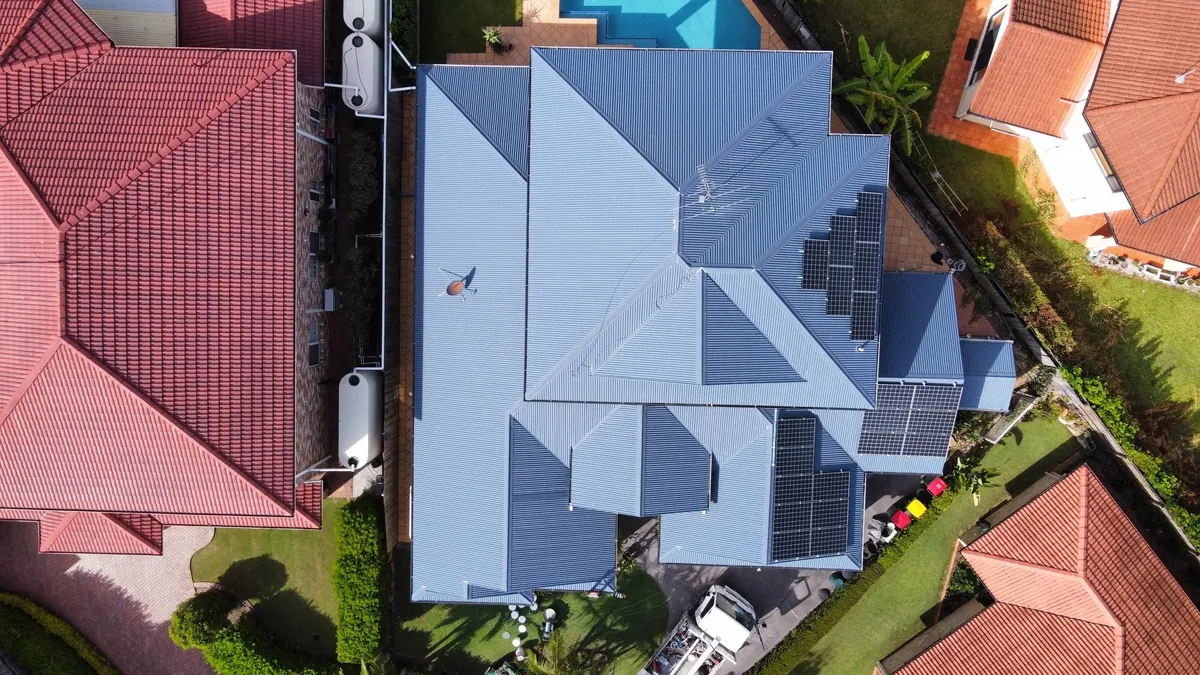 Aerial view of a tiled roof with solar panels