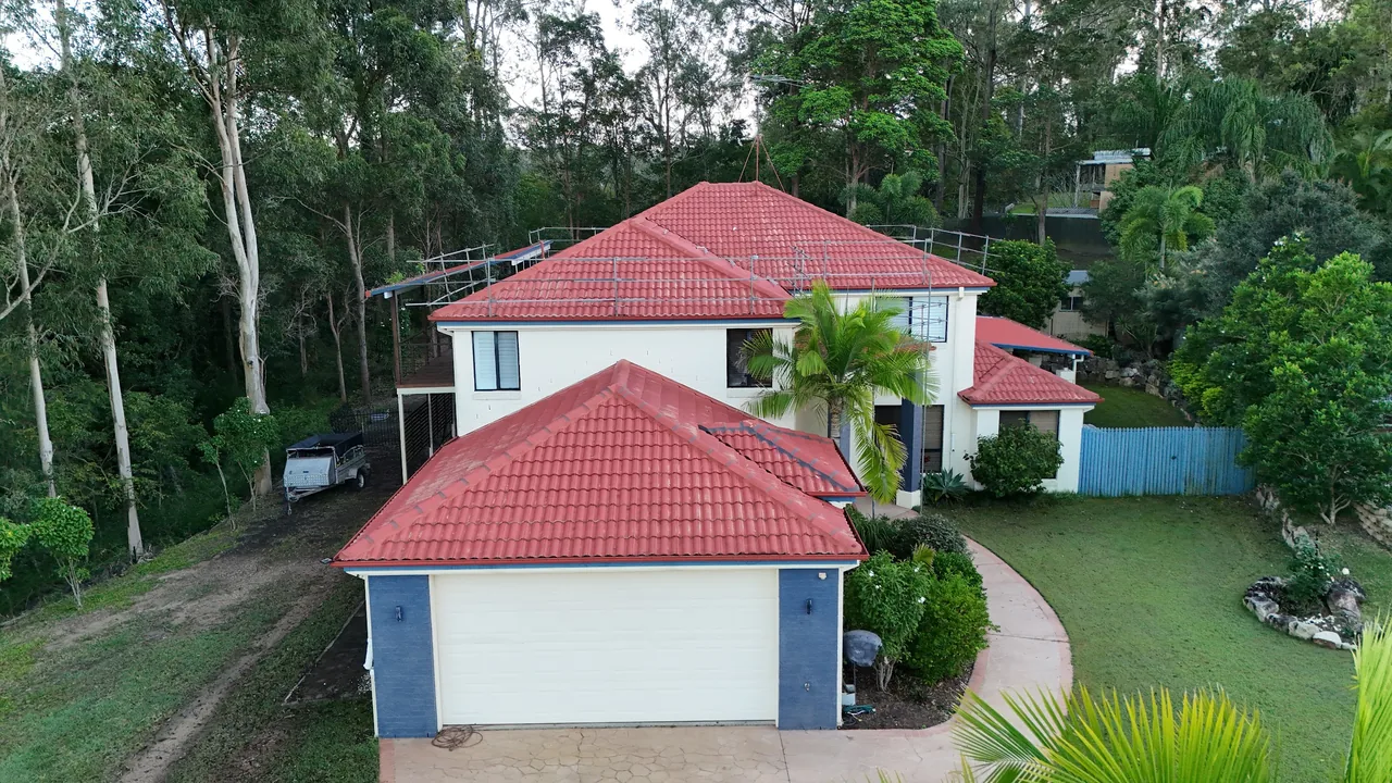Newly repainted red tile roof on a two-storey Brisbane home